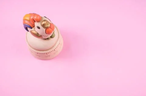 A top view of a kitchen timer in a cute chicken shape on pink background with Stock Photos