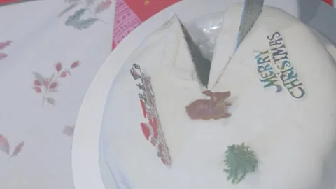 Top View of Knife Cutting into Christmas Cake with Various Winter Models Stock Footage 325847924