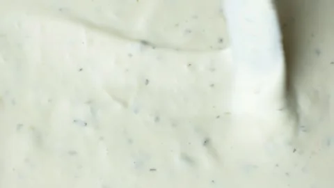 Top view of a knife smoothing creamy tartar sauce texture. Stock Footage 340167912