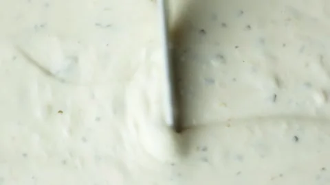 Top view of a knife smoothing creamy tartar sauce texture. Stock Footage 344797382