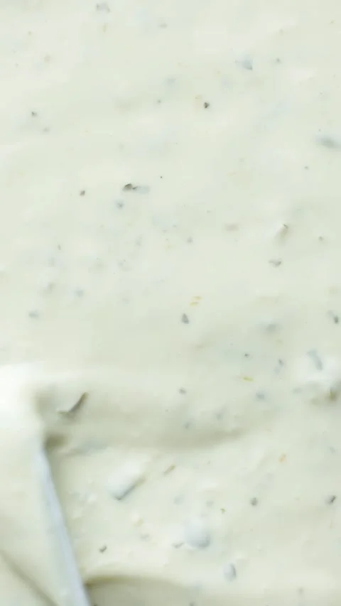 Top view of a knife smoothing creamy tartar sauce texture. Stock Footage 344952030