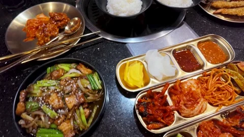 Top View of Korean Barbecue Table with Rice and Side Dishes Stock Footage 339401501