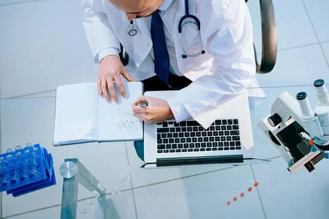 Top view. lab scientist using a laptop to save data. 스톡 사진