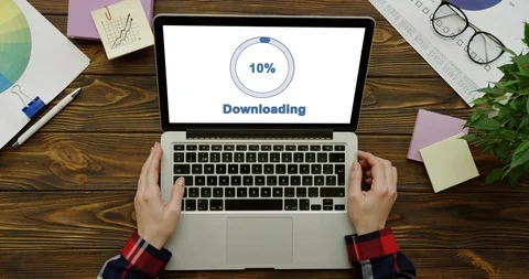 Top view on the laptop computer having a program loading on its white screen Stock Footage 95045472