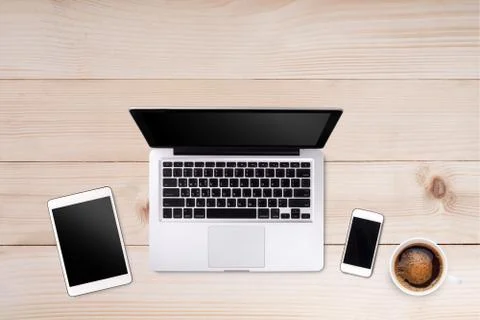 Top view laptop computer or notebook,mobile phone and cup of coffee on wood.. Stock Photos