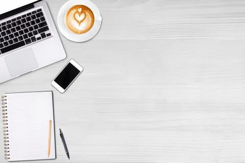 Top view laptop computer or notebook,mobile phone and cup of latte art coffee Stock Photos