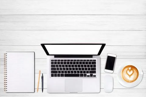 Top view laptop computer or notebook,mobile phone and cup of latte art coffee 写真素材