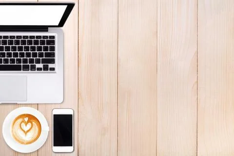 Top view laptop computer or notebook,mobile phone and cup of latte art coffee Stock Photos