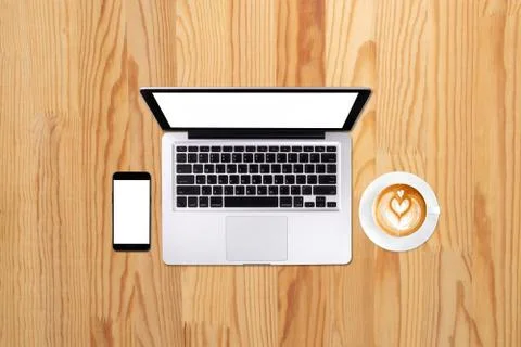 Top view laptop computer or notebook,mobile phone and cup of latte art coffee 写真素材