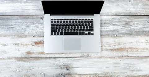 Top view of a laptop computer on white rustic wooden desktop Stock Photos