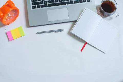Top view of laptop, cup of tea, open notebook, pen, colorful mini paper note, Stock Photos