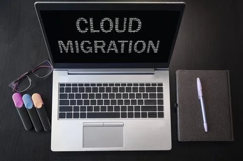 Top view of laptop with text Cloud migration Stock Photos