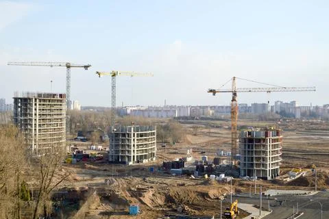 Top view of a large construction site with cranes and buildings houses concre Stock Photos