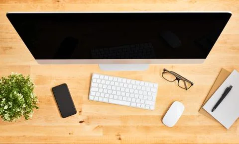 Top view of large desktop computer on wooden office desk Stock Photos
