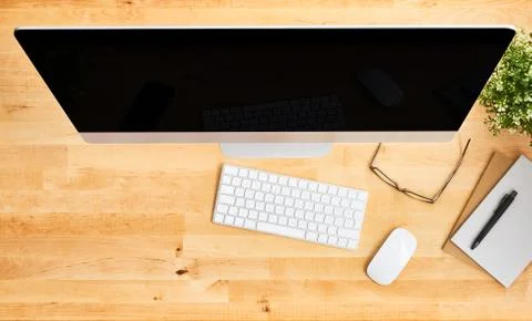 Top view of large desktop computer on wooden office desk Stock Photos