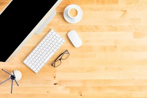Top view of large desktop computer on wooden office desk Stock Photos