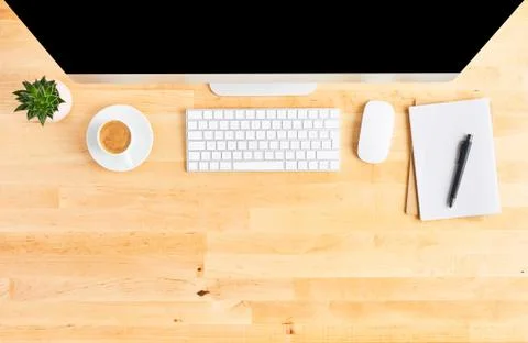 Top view of large desktop computer on wooden office desk Stock Photos