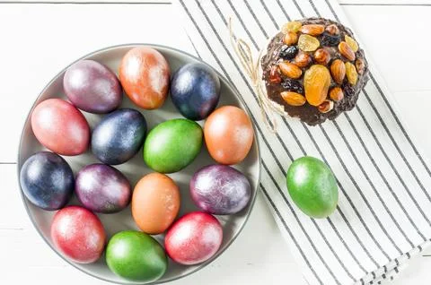 Top view of a large festive plate with colorful painted eggs for Easter. a .. Stock Photos