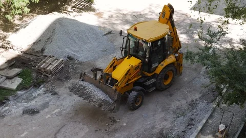 Top view. Large loader pours rubble from bucket. Road construction concept Stock Footage 111836921