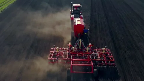 Top view of a large, modern tractor with a rotating multi-field plow on the Stock Footage 134737896