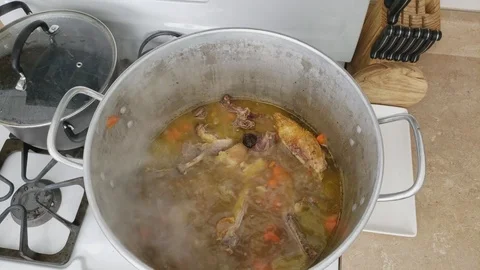 Top view of large pot of simmering previously roasted and portioned Duck Stock Footage 104250489