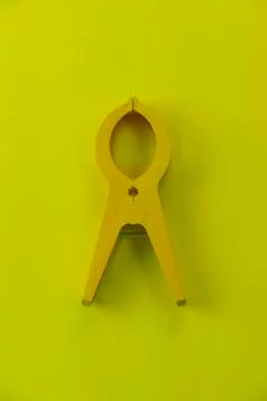 Top view of a large yellow plastic clothes pin Stock Photos