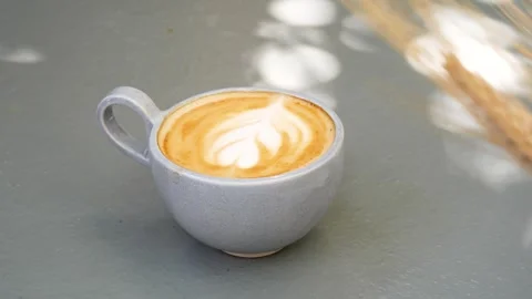 Top View Latte Art Coffee in Ceramic Mug With Sunlight Stock Footage 341827077