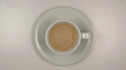 TOP VIEW: Latte coffee Drinking from a white coffee cup on a table - Stop motion Stock Footage 125290248