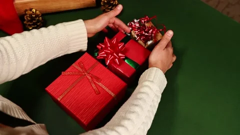 Top view of laying out gift boxes wrapped in wrapping paper with deer pattern Stock Footage 221024279