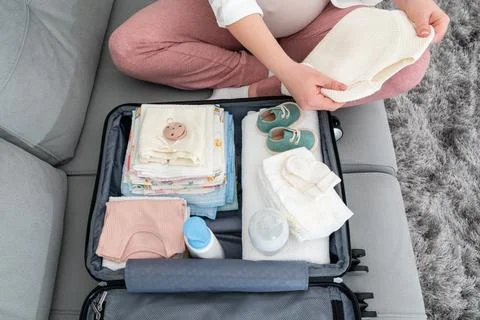 Top view of laying out a set of necessary things in a European maternity Stock Photos