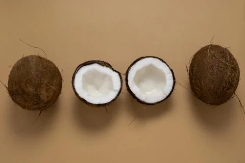 Top view layout of fresh coconuts row on a brown background Stock Photos
