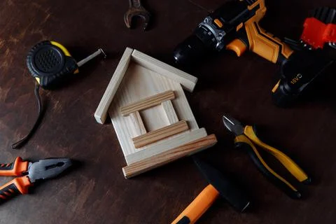 Top view layout of tools and house model on a wooden background Stock Photos