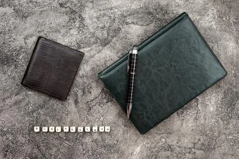 Top view leather notebook lying on a plaster background. Inscription busine.. Stock Photos