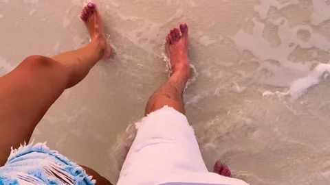Top view of the legs Walking a couple in love along the shore of Bora Bora Stock Footage 239009197