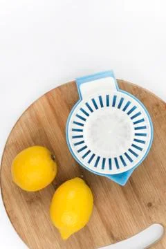 Top view of lemons and strainer on a wooden board Stock Photos