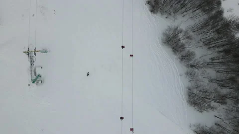 Top view of the lift moving on the cable car in the ski resort. The drone flies Stock Footage 177490267