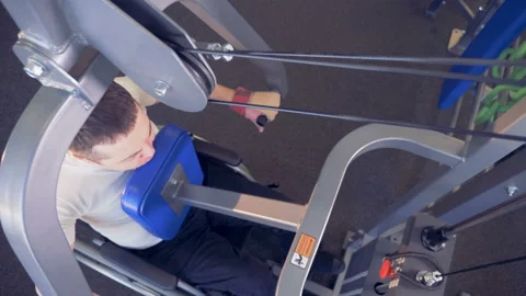 Top view of a lift-weighting machine being used by a handicapped man during Stock Footage 87607618