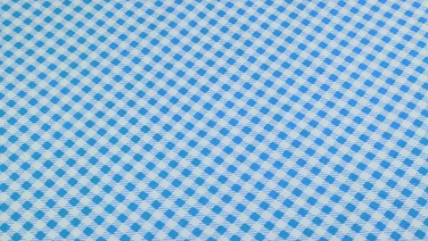 Top view of the light blue and white color cage cotton fabric rotated Stock Footage 293878053