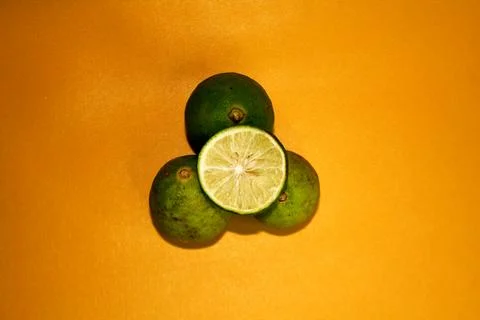 Top view of lime with orange background. Stock Photos