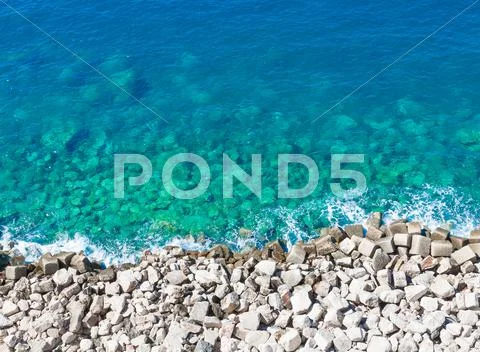 Top of view limpid water on gravel beach Stock Photos
