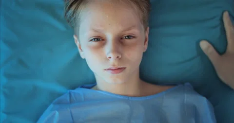 Top view of little boy lying on transportation cart while paramedic checking 스톡 동영상 137622129