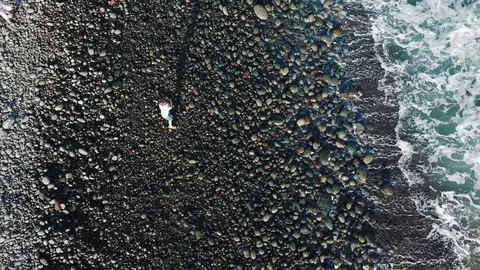 Top view on little boy is playing on a beach with pebble and throwing it into Stock Footage 95416653