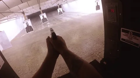 Top view of loading pistol and shooting target ahead Vídeos de archivo 61094203