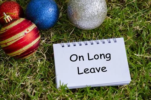Top view of On Long Leave text on white notepad with Christmas decoration b.. Photos