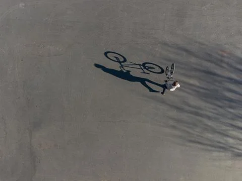 Top view of long shadow of a man on a bicycle Stock Photos