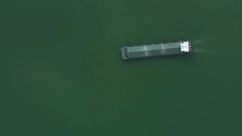 Top view of a long small cargo ship sailing in a canal Stock Footage 234733609
