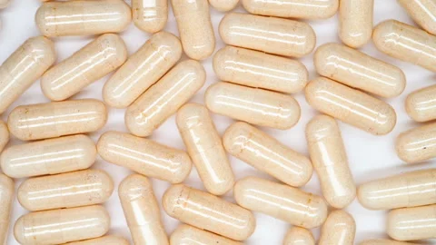Top view lots of capsules turning Stock Footage 141589702