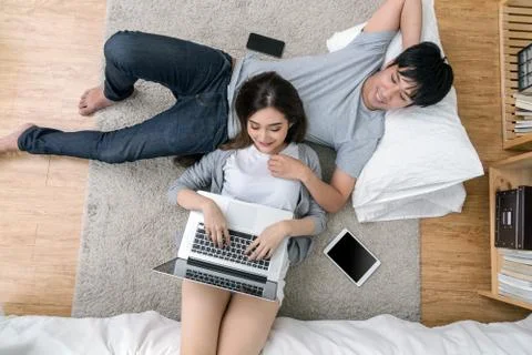 Top view of Lover using the technology digital laptop sleeping on the Parquet Stock Photos
