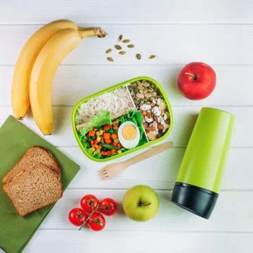 Top view of lunch box on light wooden background Stock Photos