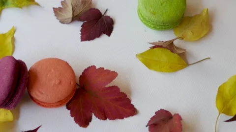Top view of macarons on a white background surrounded by autumn leaves. autumn Видео 139148867